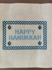 Happy Hanukkah printed needlepoint canvas close-up with blue checked border and dreidels