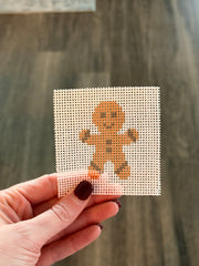 Gingerbread Man Stitch Snacks mini, unstitched printed 13-mesh needlepoint canvas held in hand