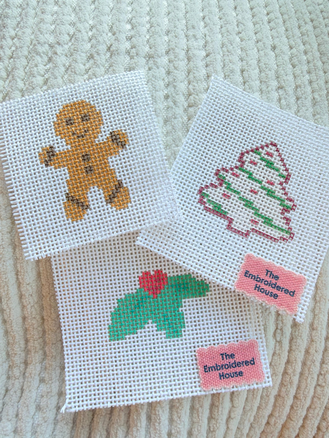 Holiday Stitch Snacks trio of gingerbread man, Christmas tree cake, and holly sprig mini needlepoint canvases